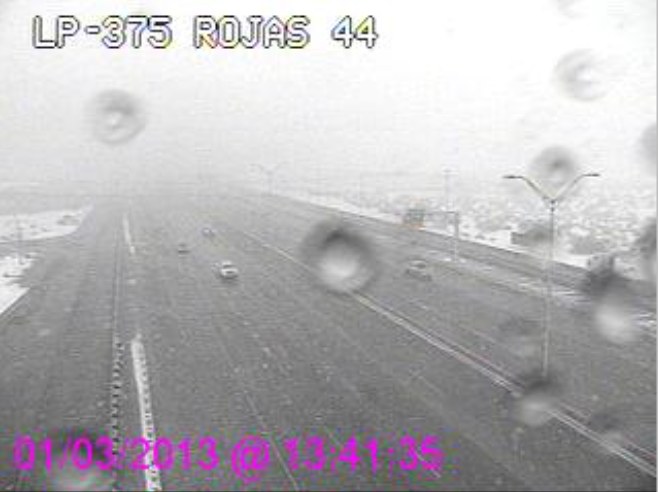 WTI Sidewinder view of Loop 375 at Rojas with snow melting to droplets on the window