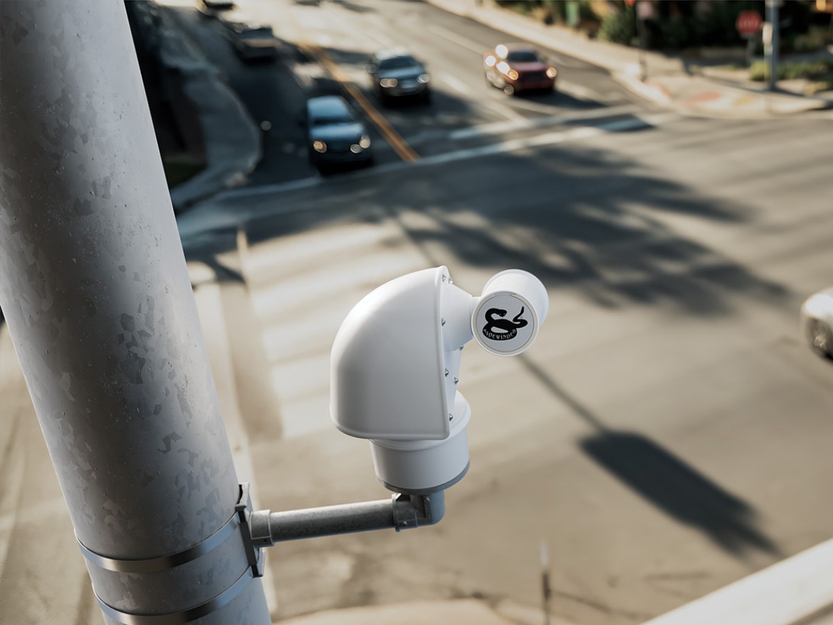 Sidewinder PTZ camera on a side-of-pole mount above a signalized intersection